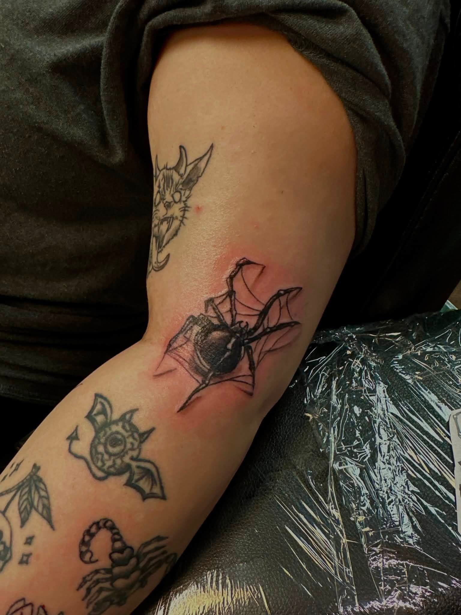 Black bat forearm tattoo